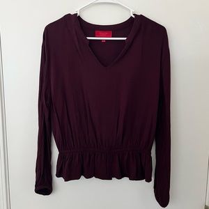 Jennifer Lopez maroon long sleeve top with cinched waist and sleeves. Notch neck